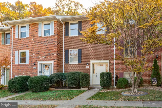 front view of a brick house next to a yard