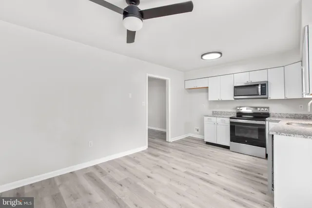 a kitchen with stainless steel appliances a stove top oven a sink and dishwasher