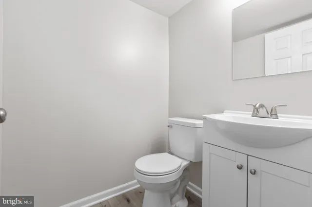 a bathroom with a sink a toilet and mirror