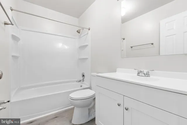 a bathroom with a sink a toilet and vanity