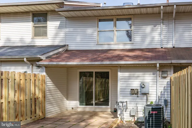 a view of a house with wooden fence