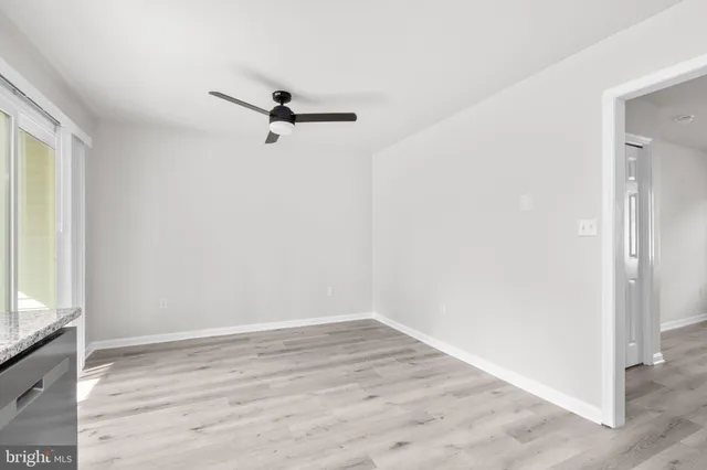 a view of a room with wooden floor and fan
