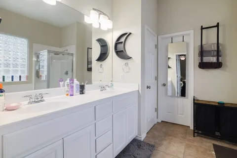 a bathroom with a sink vanity and mirror