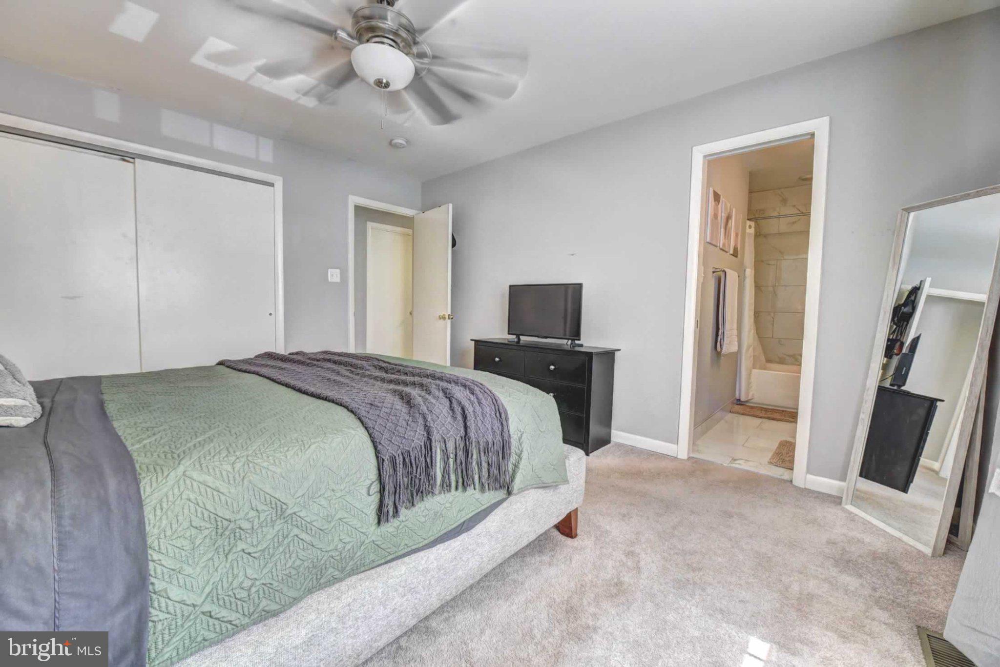 2226 Gunsmith Square Reston, VA 20191 - Photo 19 of 35 a spacious bedroom with a bed and a flat screen tv