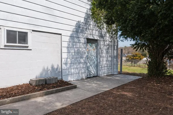 a view of a house with a door and wooden walls