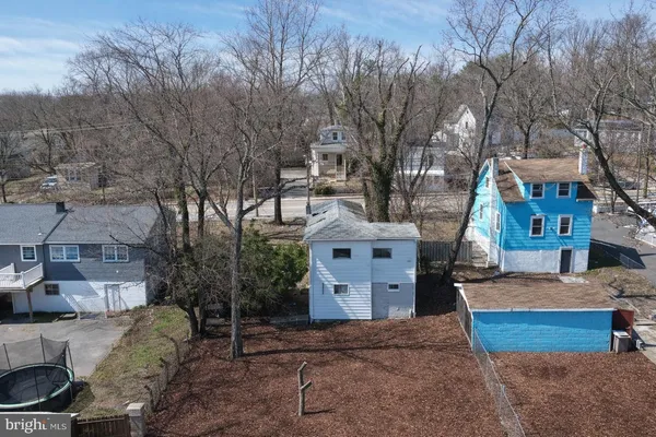 an aerial view of multiple houses with yard