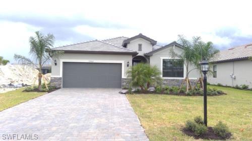 19867 Beverly Park Road Estero, FL 33928 - Photo 1 of 1 a front view of a house with garden