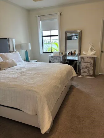 a spacious bedroom with a bed and a window