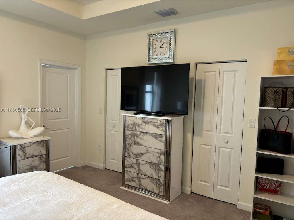 3350 Northwest 112th Street Hialeah, FL 33018 - Photo 12 of 40 a bedroom with a bed and a television