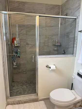 a bathroom with a shower and a toilet