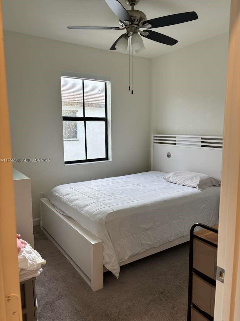 3350 Northwest 112th Street Hialeah, FL 33018 - Photo 15 of 40 a bedroom with a bed and a window