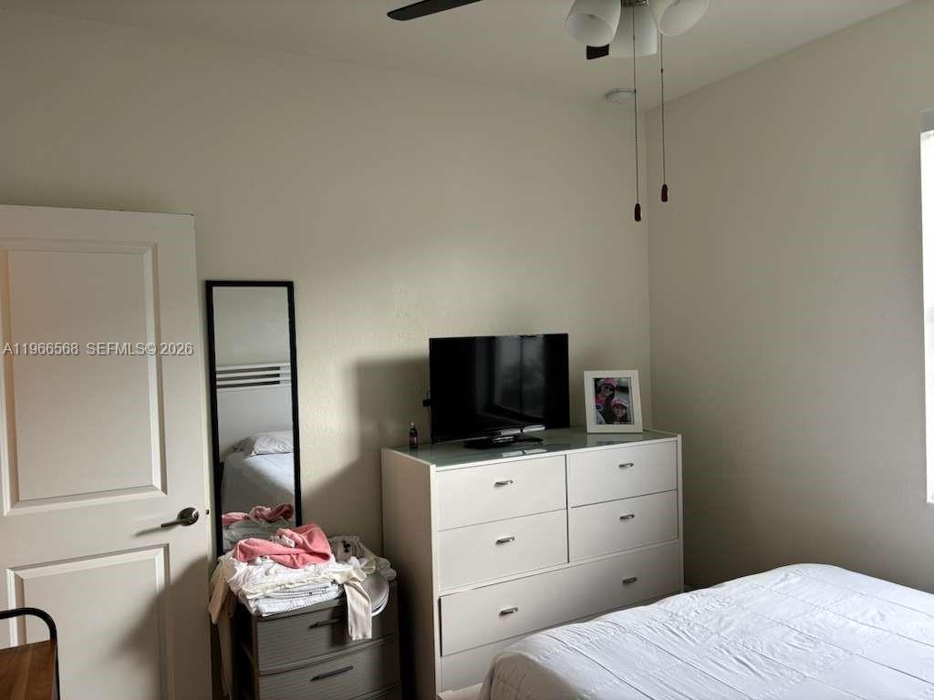 3350 Northwest 112th Street Hialeah, FL 33018 - Photo 16 of 40 a bedroom with a bed and a flat tv screen on dresser
