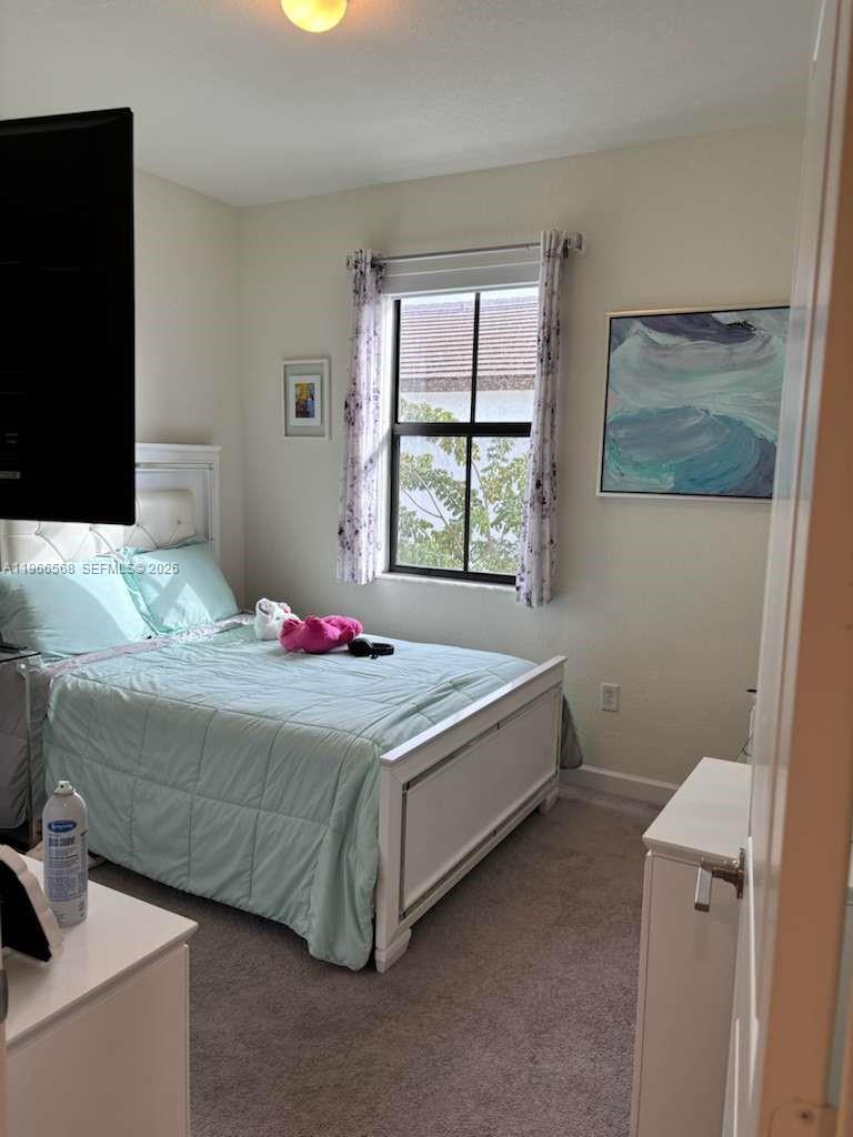 3350 Northwest 112th Street Hialeah, FL 33018 - Photo 17 of 40 a bedroom with a bed and a window