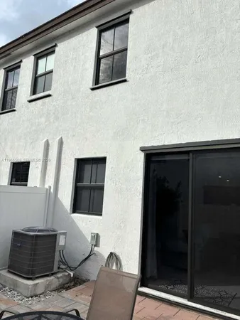 a living room with furniture and a lamp