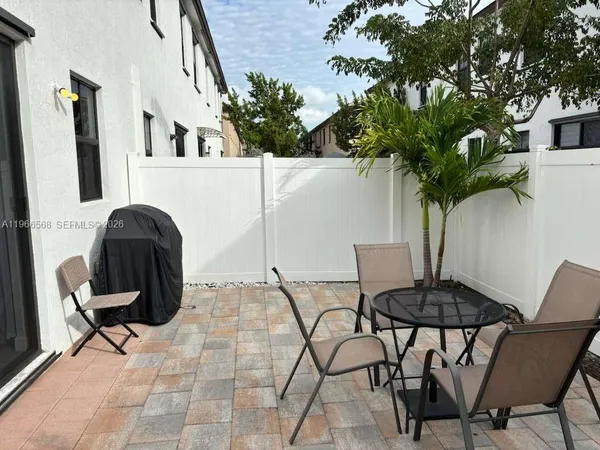 a view of a chairs and table in a patio