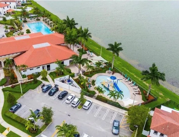 an aerial view of a house with a yard and outdoor seating