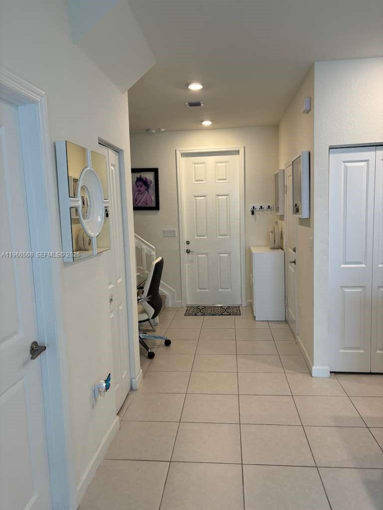 3350 Northwest 112th Street Hialeah, FL 33018 - Photo 6 of 40 a view of a storage & utility room with refrigerator and mirror