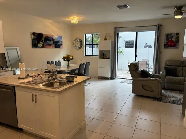a kitchen with a sink and a stove top oven