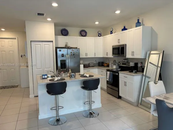 a kitchen with a sink stainless steel appliances and cabinets