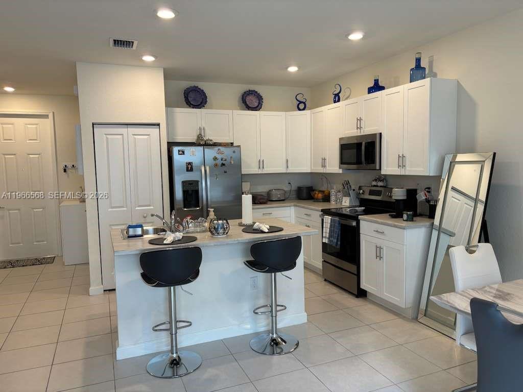 3350 Northwest 112th Street Hialeah, FL 33018 - Photo 8 of 40 a kitchen with a sink stainless steel appliances and cabinets