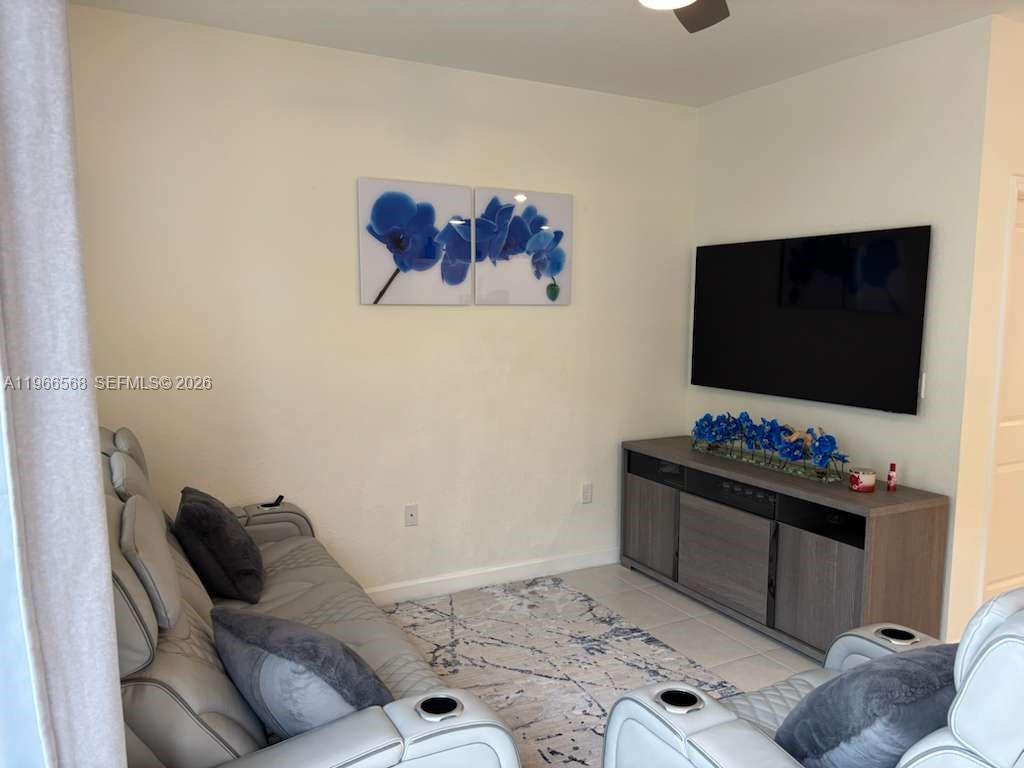 3350 Northwest 112th Street Hialeah, FL 33018 - Photo 10 of 40 a living room with furniture and a flat screen tv
