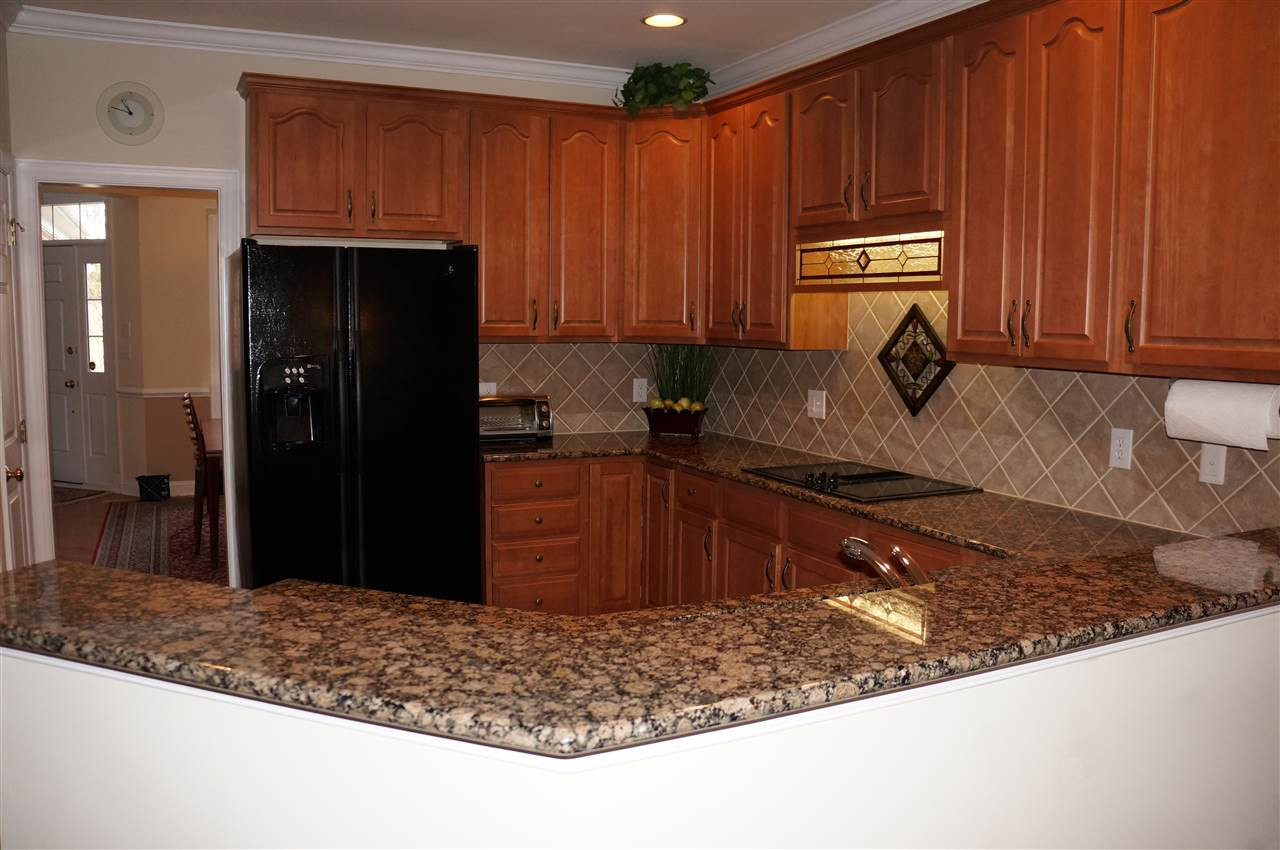 10913 Clovermill Circle Raleigh, NC 27617 - Photo 9 of 25 The breakfast bar seperates the kitchen area from the family room and breakfast room! Great area to entertain! Breakfast Bar