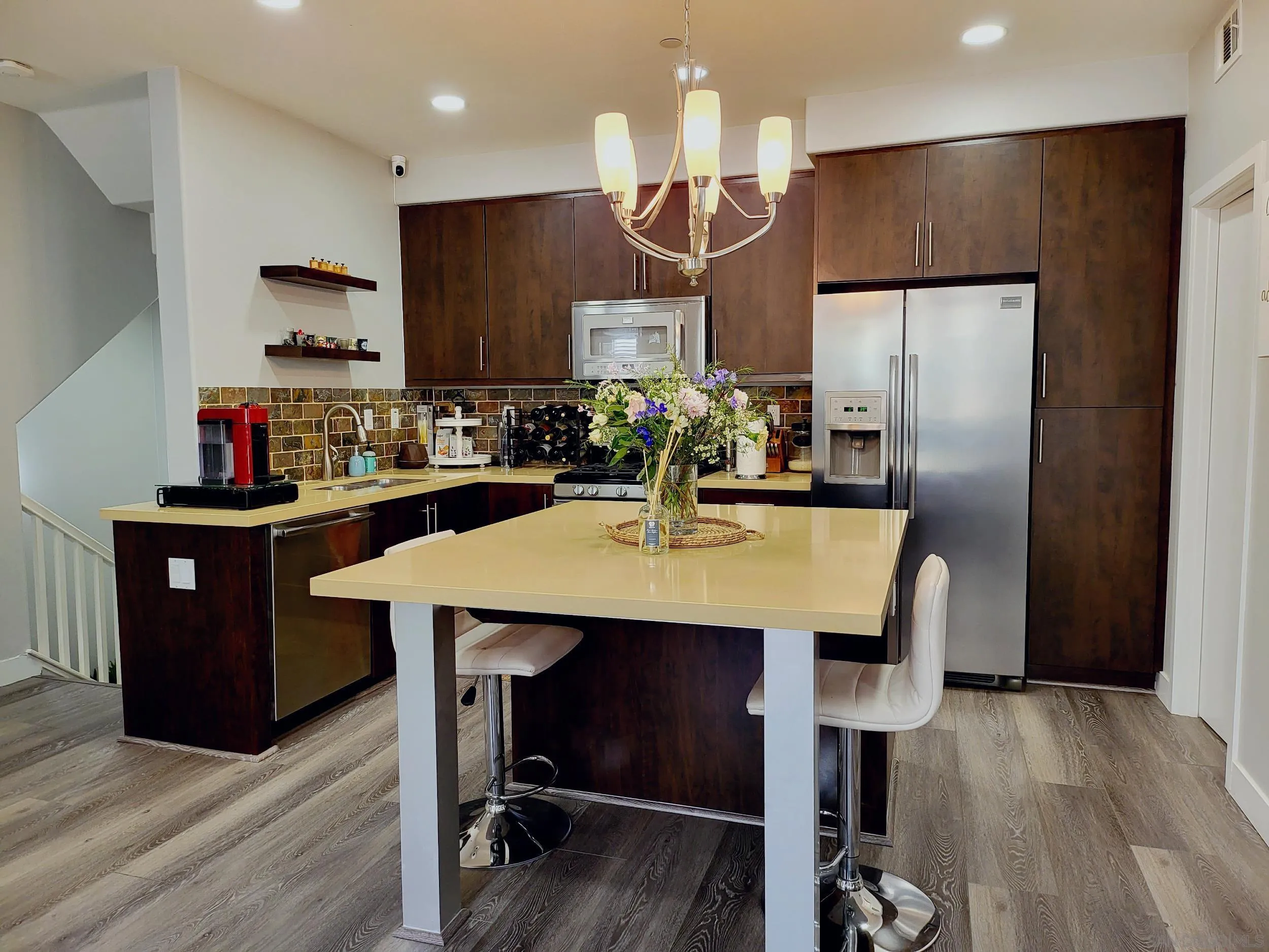 2152 Cosmo Way San Marcos, CA 92078 - Photo 1 of 28 a kitchen with stainless steel appliances a dining table chairs refrigerator and microwave