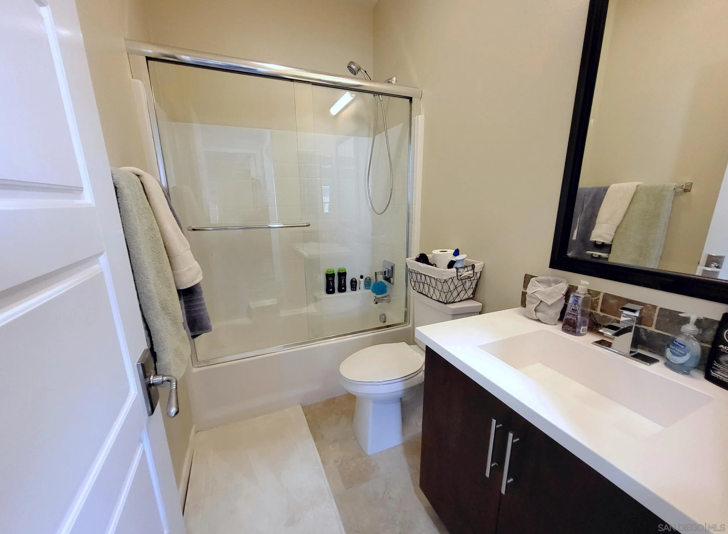 2152 Cosmo Way San Marcos, CA 92078 - Photo 14 of 28 a bathroom with a sink a toilet a mirror and shower
