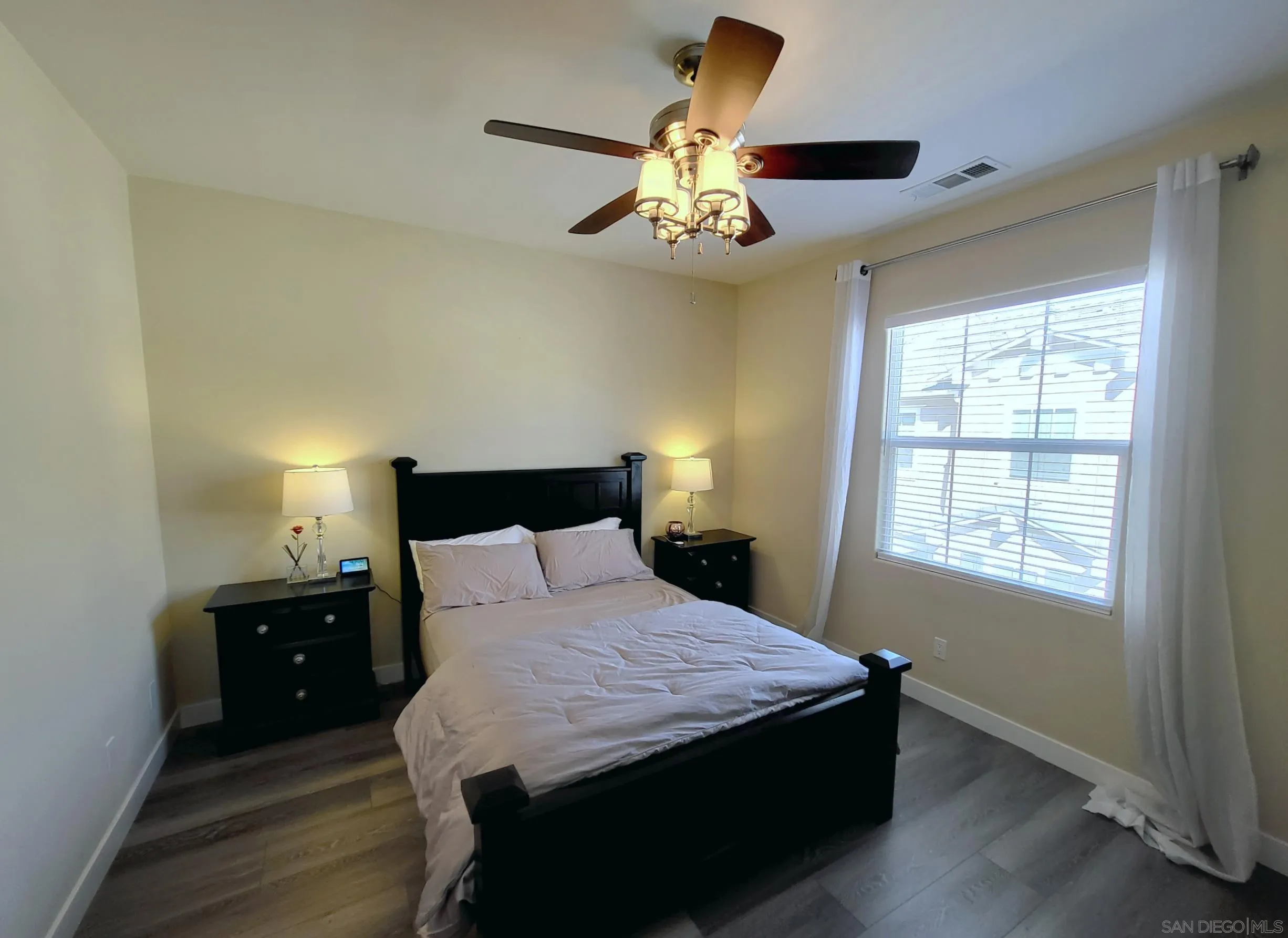 2152 Cosmo Way San Marcos, CA 92078 - Photo 10 of 28 a bedroom with a bed and a chandelier