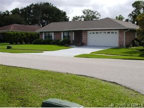 520 Sandpiper Court Edgewater, FL 32141 - Photo 3 of 7 a front view of a house with a yard and garage