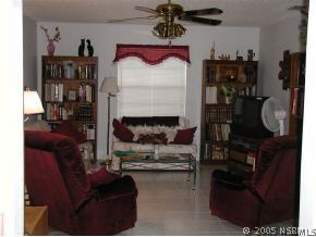 520 Sandpiper Court Edgewater, FL 32141 - Photo 4 of 7 a living room with furniture and a fireplace