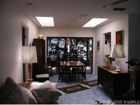 520 Sandpiper Court Edgewater, FL 32141 - Photo 5 of 7 a living room with furniture a lamp and a potted plant