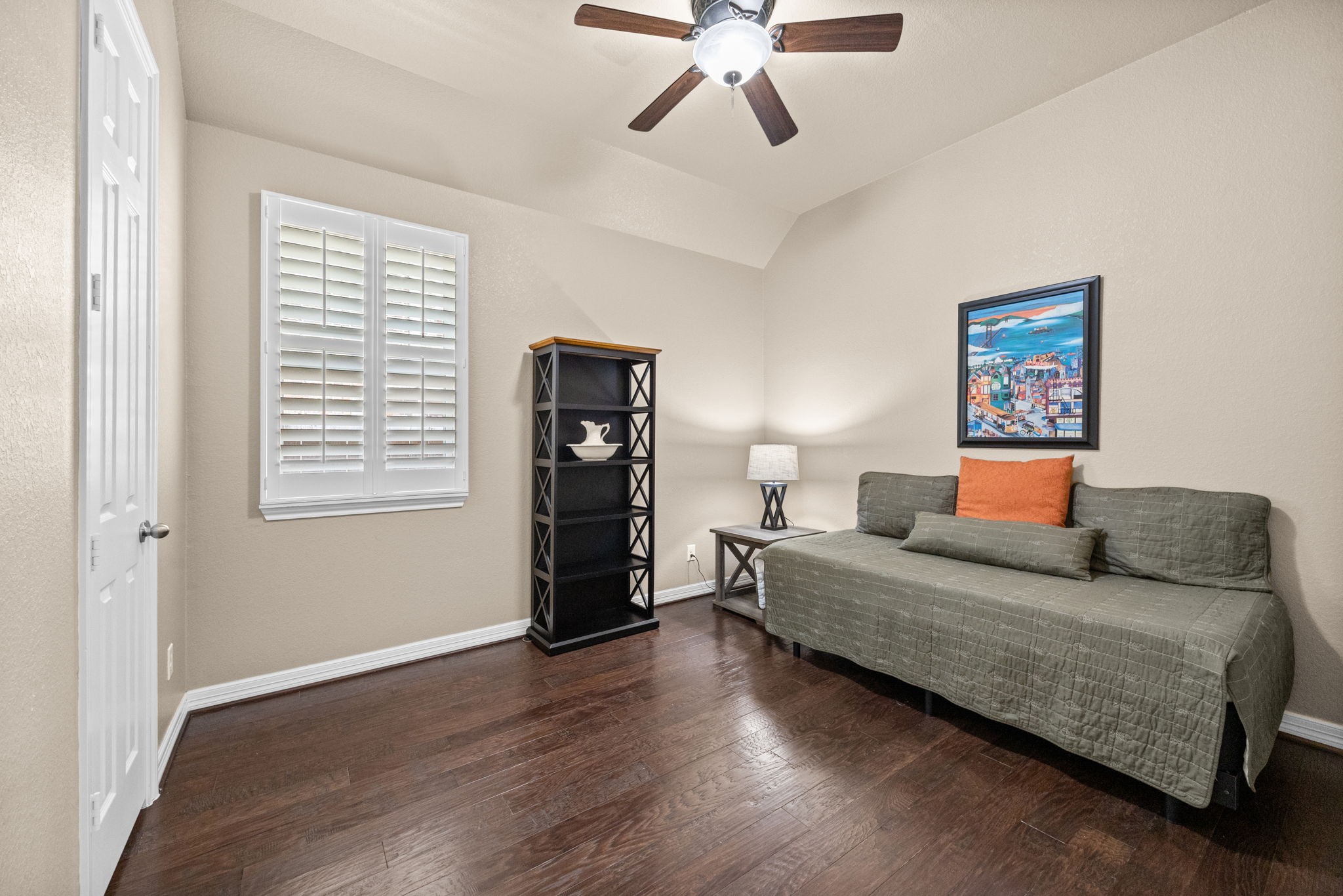 27642 Linden Ridge Lane Fulshear, TX 77441 - Photo 24 of 42 This Bedroom features wood flooring, Plantation Shutters on the windows, a 5-blade ceiling fan, and a walk-in closet, providing a comfortable and well-appointed space with both style and functionality.