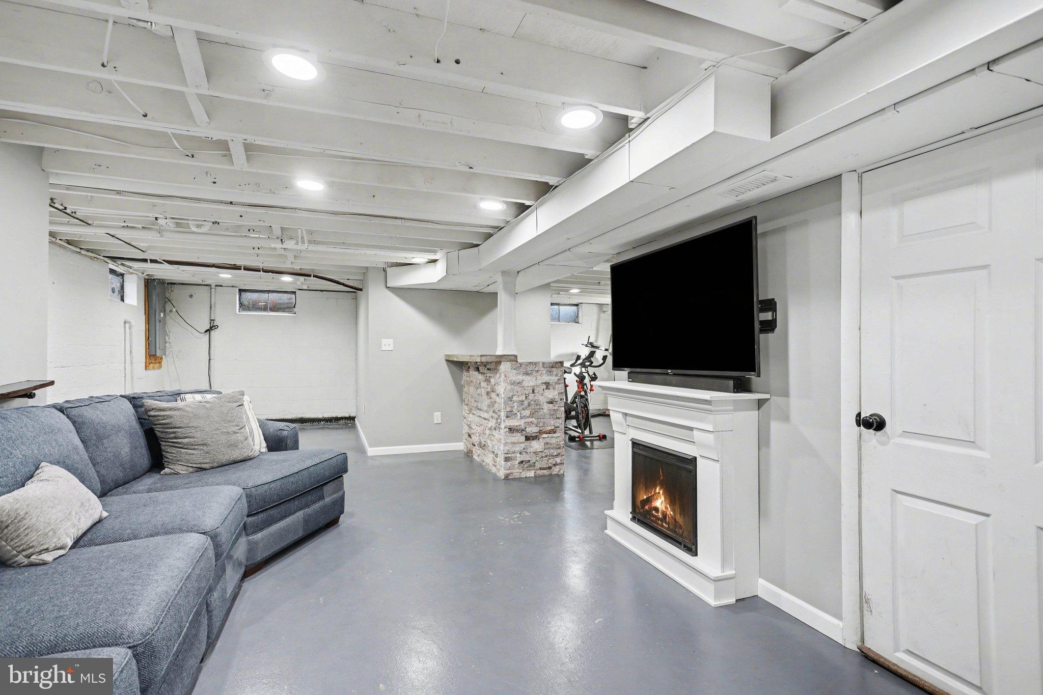 2848 Kissel Hill Road Lancaster, PA 17601 - Photo 25 of 36 a living room with furniture a flat screen tv and a fireplace