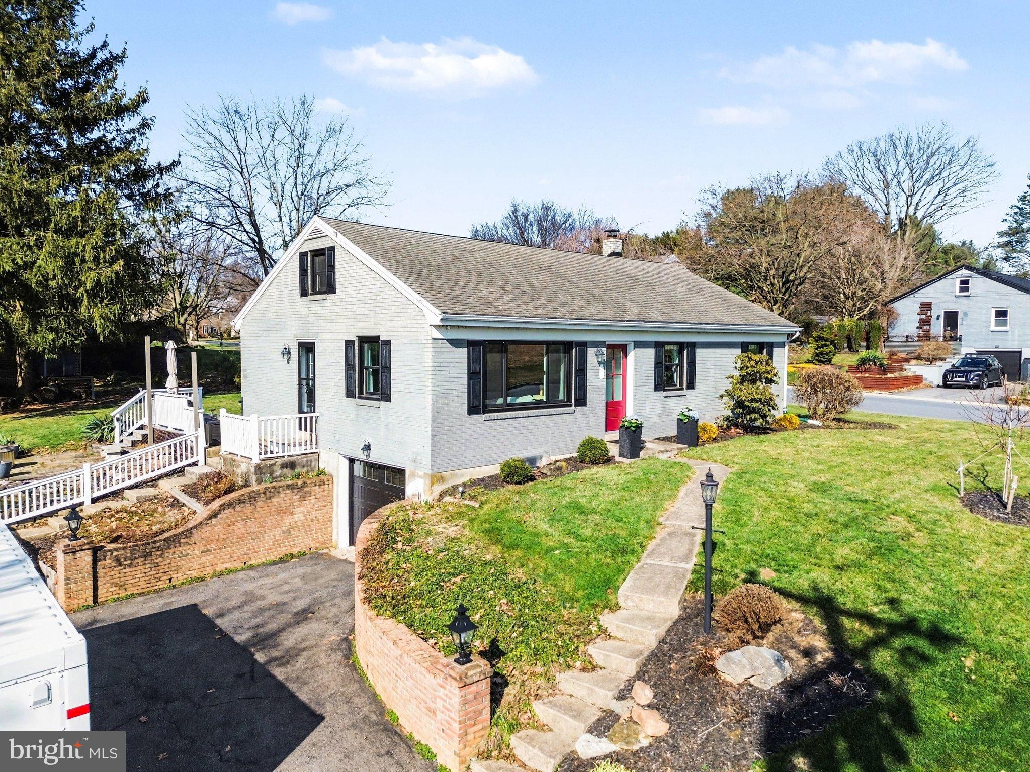 2848 Kissel Hill Road Lancaster, PA 17601 - Photo 5 of 36 a front view of a house with a yard table and chairs