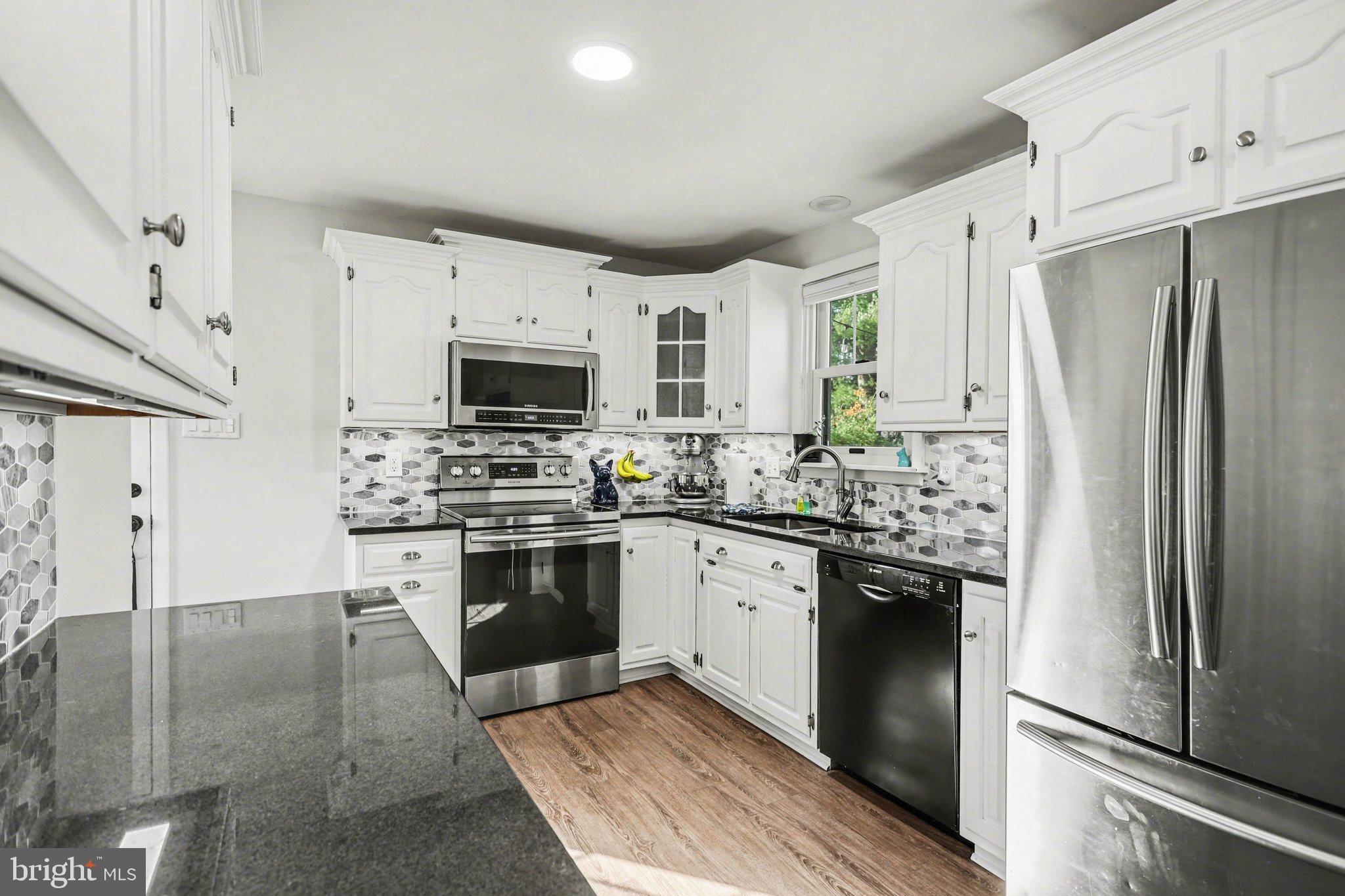 2848 Kissel Hill Road Lancaster, PA 17601 - Photo 8 of 36 a kitchen with stainless steel appliances granite countertop a refrigerator stove and sink