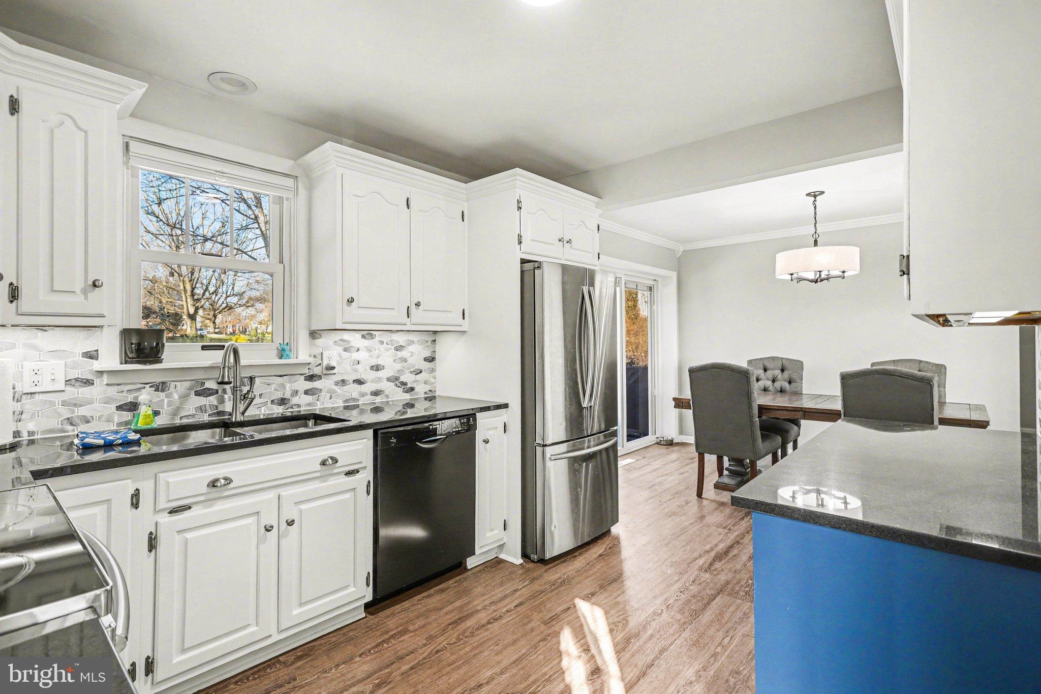 2848 Kissel Hill Road Lancaster, PA 17601 - Photo 9 of 36 a kitchen with stainless steel appliances granite countertop a refrigerator a sink dishwasher and white cabinets with wooden floor