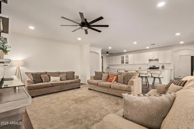 a living room with furniture and a view of kitchen