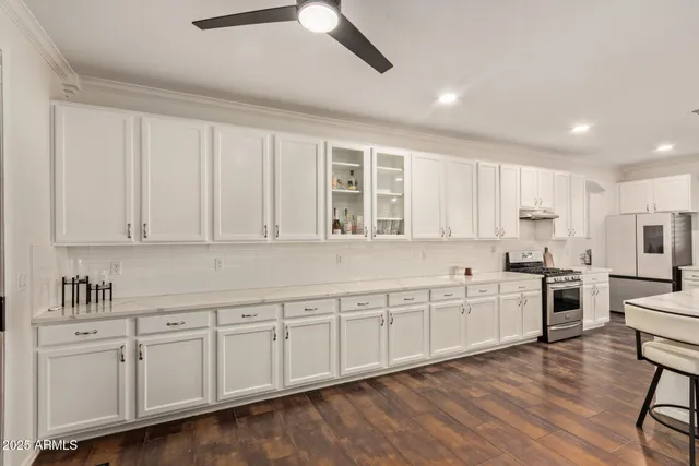 a kitchen with white cabinets and sink