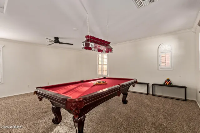 a room with pool tables and windows