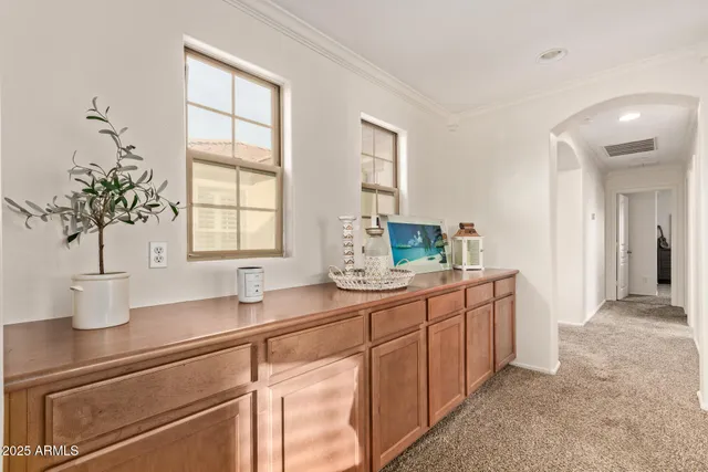 a kitchen with stainless steel appliances a sink a window and cabinets