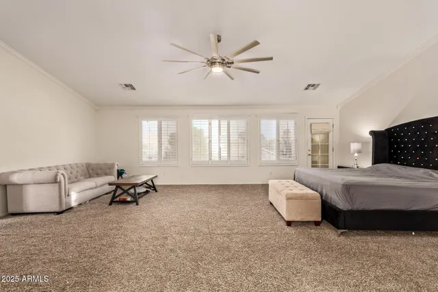 a spacious bedroom with a bed and a couch