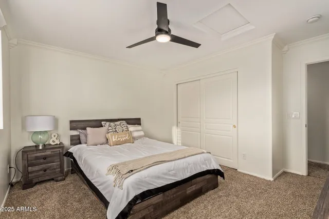 a bedroom with a bed and a night stand