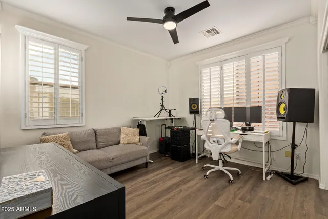a view of a livingroom with workspace and a window
