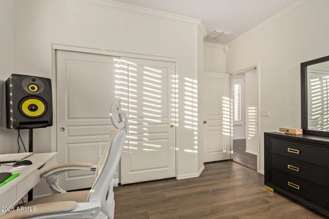 a view of a hallway with wooden floor and windows