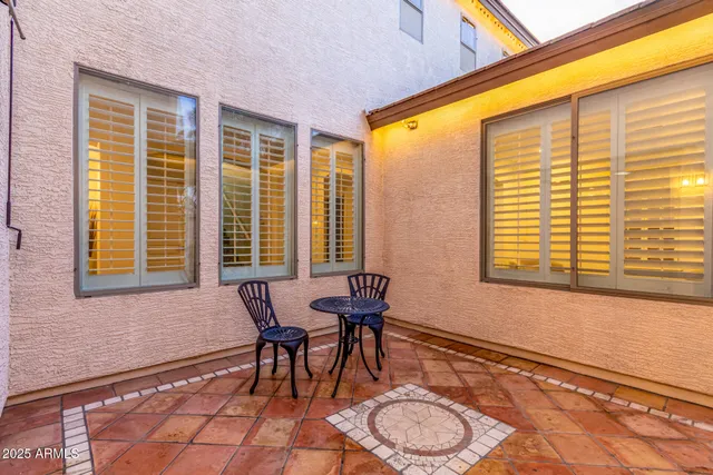 a balcony with table and chairs