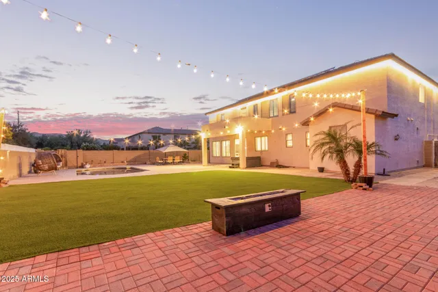 a swimming pool with an outdoor space and seating area
