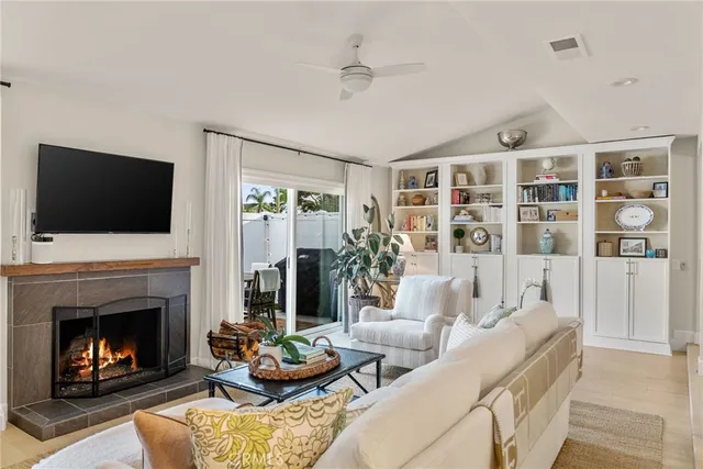 a living room with furniture fireplace and flat screen tv