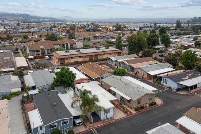 an aerial view of a house with swimming pool and sitting area