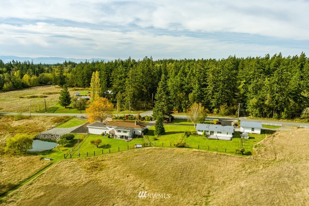 854 Devries Road Oak Harbor, WA 98277 - Photo 6 of 40 a view of yard with swimming pool and trees in the background